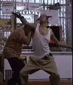 man in white tank top gets shot