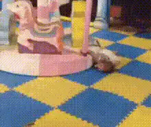 Toddler dragged by spinning carousel