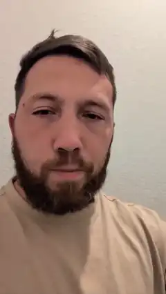 Man with beard looking at camera