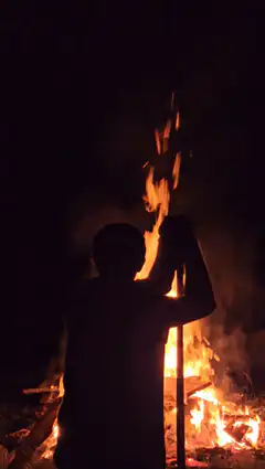 Person holding torch at night