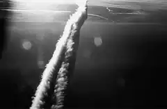 Airplane leaving contrail in sky