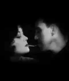 Charlie Chaplin and woman sharing a cigarette