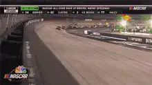 NASCAR race cars speeding around a track