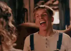 Man in overalls laughing hysterically