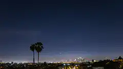 Blue fireball meteor over city at night