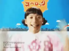 Man in wig waving hands excitedly