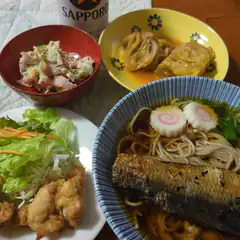 Japanese meal with soba, fish, salad, and Sapporo beer