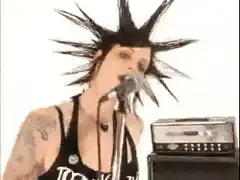 Punk singer with spiky hair singing into microphone