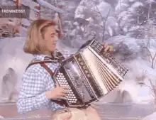 Man playing accordion in snow