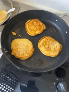 three pancakes cooking in a pan