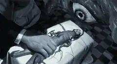sawing off a doll's head