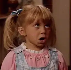 Little girl with pigtails looks up in shock