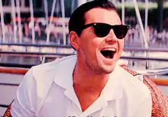 Leonardo DiCaprio laughing on a boat