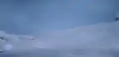 Man sliding down snowy hill