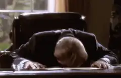 Old man faceplanting on desk