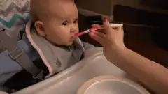 Baby smiles while being fed