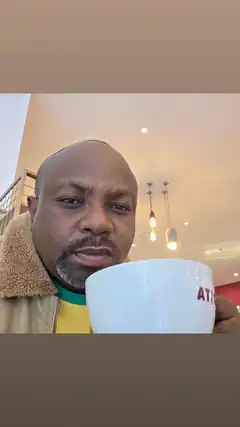 Man holding a white mug with red text