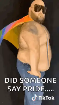 Bald man with rainbow cape says pride