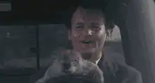 Bill Murray holding a groundhog