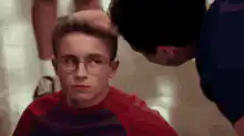 Boy with glasses looks up