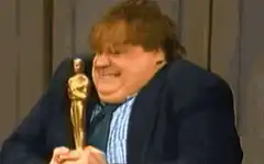 John Goodman hugging Oscar statue