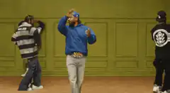 Man in blue hoodie dancing in studio