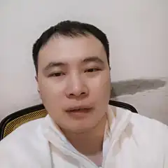 Man in white jacket looking at camera