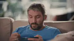 Man eating cereal while watching TV