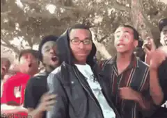 Man in hoodie surrounded by shocked crowd