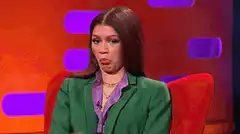 Zendaya examining her hand