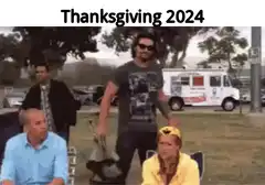 Guy picking up chair Thanksgiving 2024