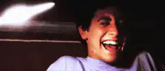 Man laughing hysterically in car