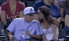 Man and woman talking at a sports game