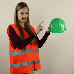 Woman in safety vest pointing to head