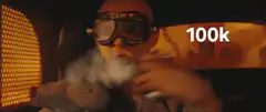 Bald man in goggles smoking a vape