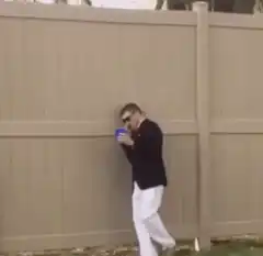 Man falls over fence while on phone