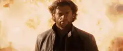 Hugh Jackman standing in front of explosion