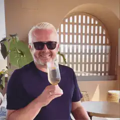 Man in sunglasses toasts with champagne