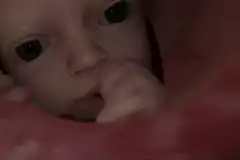 Baby sucking thumb close up