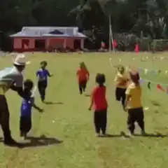 kids running race on grass field