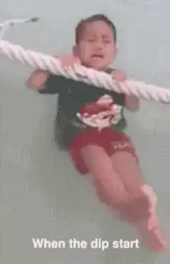 Crying toddler held by rope in water