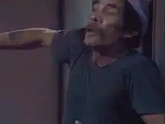 Man in hat laughing hysterically