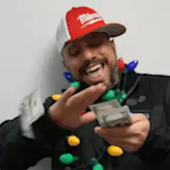Man laughing with money and Christmas lights