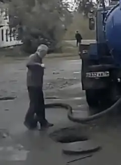 Man steps on hose and gets sucked into manhole