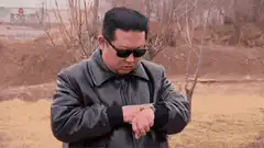 Kim Jong-un and general checking watches