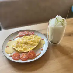 Omelette and Matcha Latte on Wooden Table