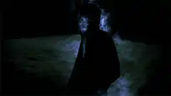 Silhouette figure dissolving into light particles