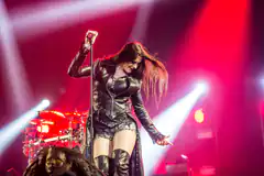 female singer in leather outfit on stage