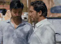 Two men shake hands