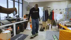 Man skateboarding indoors in office